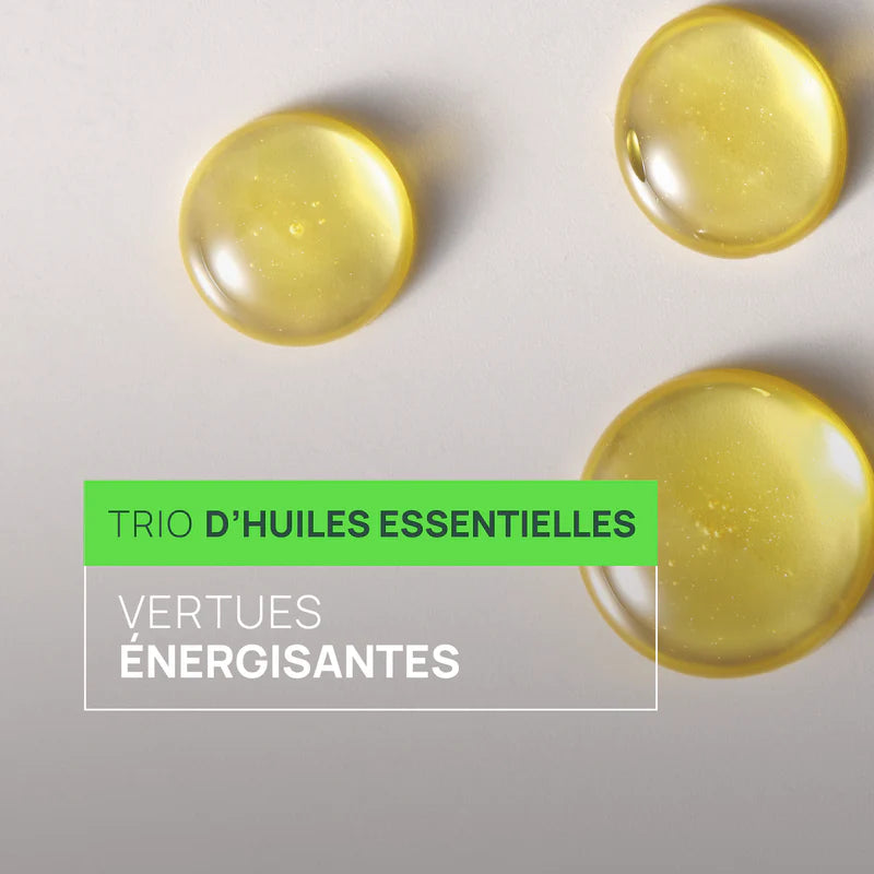 Gouttes d’huile jaune sur fond clair avec mention trio d’huiles essentielles énergisantes, visuel cosmétique naturel et purifiant