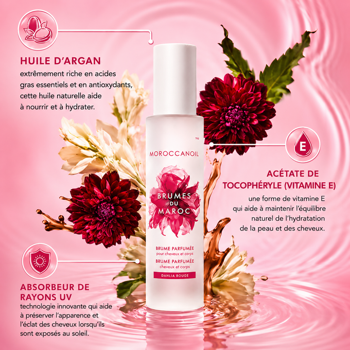Brume parfumée Moroccanoil Dahlia Rouge pour cheveux et corps dans un flacon givré blanc avec fleurs rouges luxuriantes et informations sur l’huile d’argan et la vitamine E sur fond rose.