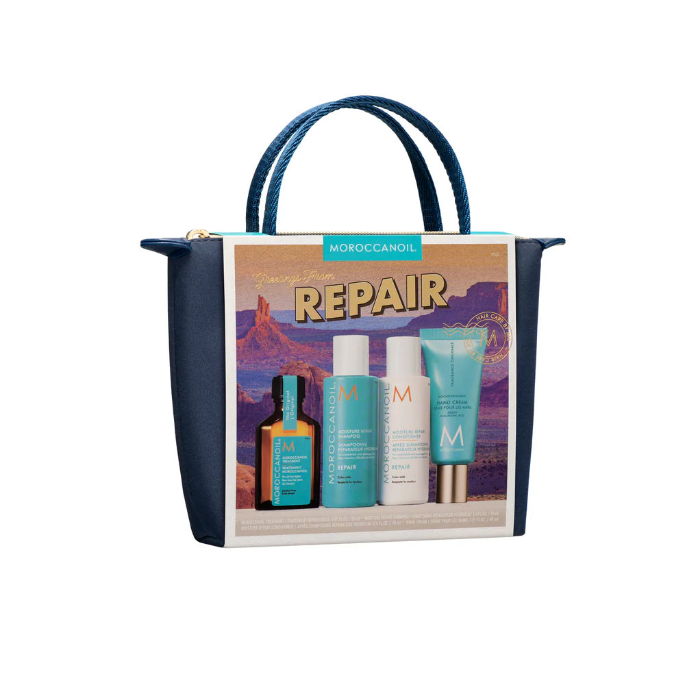 Coffret Moroccanoil Repair placé dans une pochette bleu marin avec shampoing, revitalisant, huile Moroccanoil et crème pour les mains sur fond blanc. 